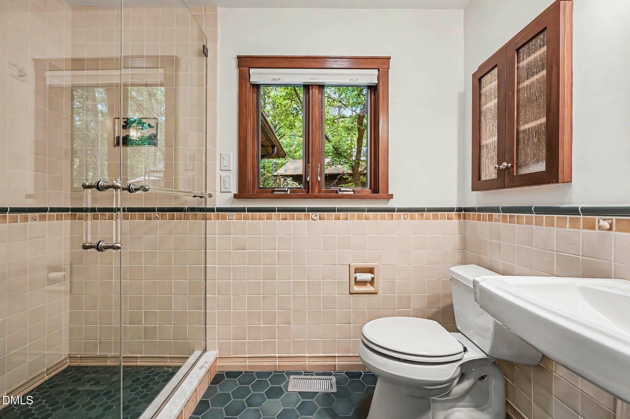 200 Spring Valley Road Carrboro, NC 27510 - Photo 20 of 38 a bathroom with a toilet a sink and a shower
