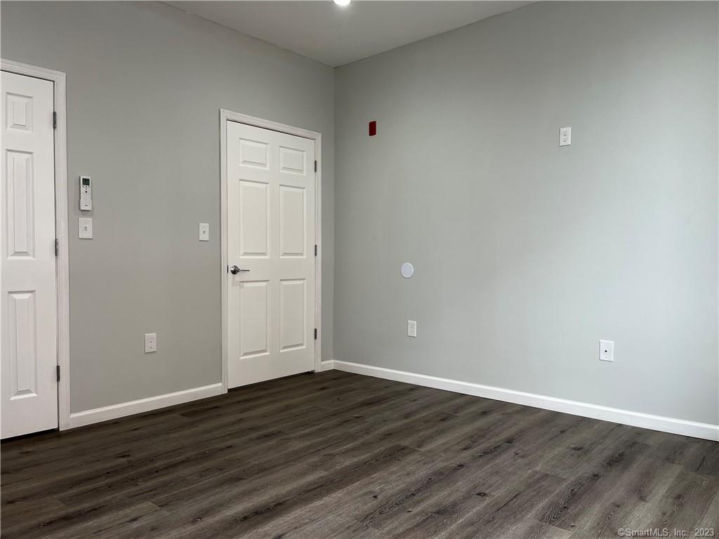 893 Main Street, Unit 202 Manchester, CT 06040 - Photo 7 of 10 a view of an empty room with wooden floor