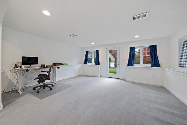 a view of a livingroom with workspace and a window