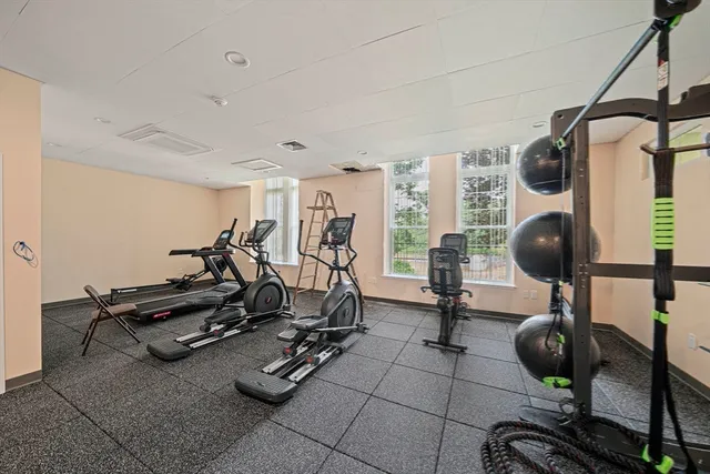 a room with gym equipment and windows