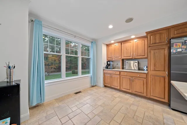a open kitchen with granite countertop a refrigerator and a sink