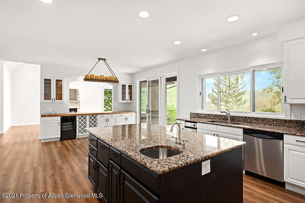 400 Medicine Bow Road Aspen, CO 81611 - Photo 13 of 58 a kitchen with granite countertop a sink and a stove