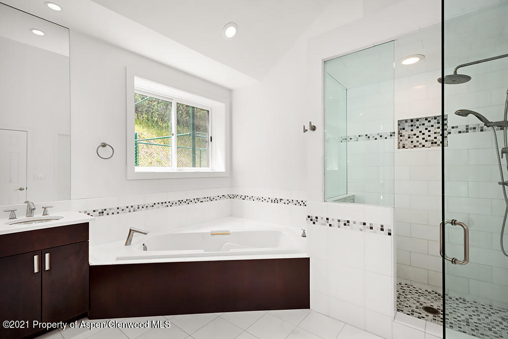 400 Medicine Bow Road Aspen, CO 81611 - Photo 19 of 58 a bathroom with a bathtub and a sink