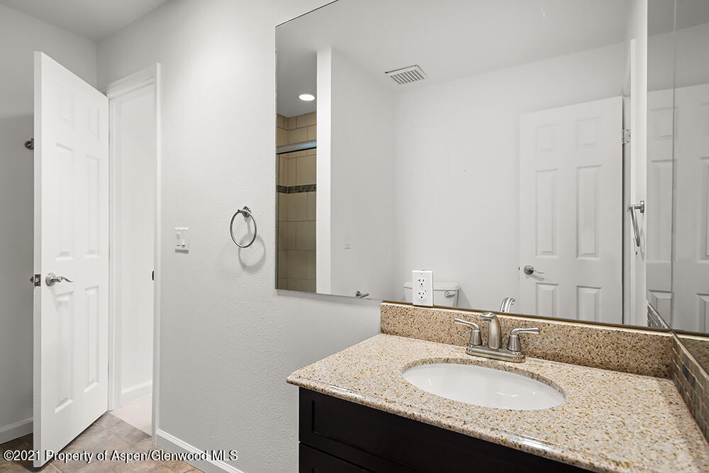 400 Medicine Bow Road Aspen, CO 81611 - Photo 24 of 58 a bathroom with a granite countertop sink and a mirror