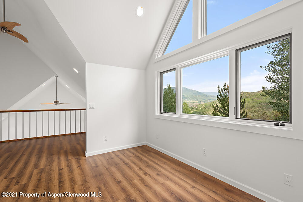 400 Medicine Bow Road Aspen, CO 81611 - Photo 31 of 58 a view of a room with wooden floor and windows