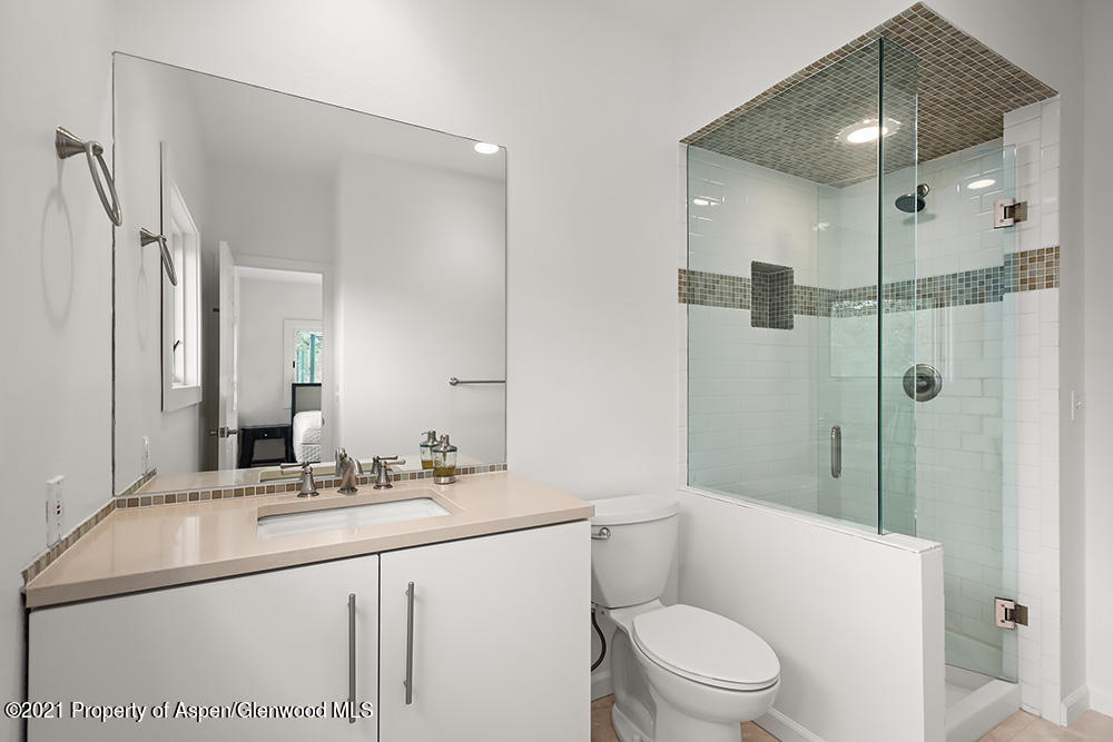 400 Medicine Bow Road Aspen, CO 81611 - Photo 39 of 58 a bathroom with a sink a toilet a mirror and shower