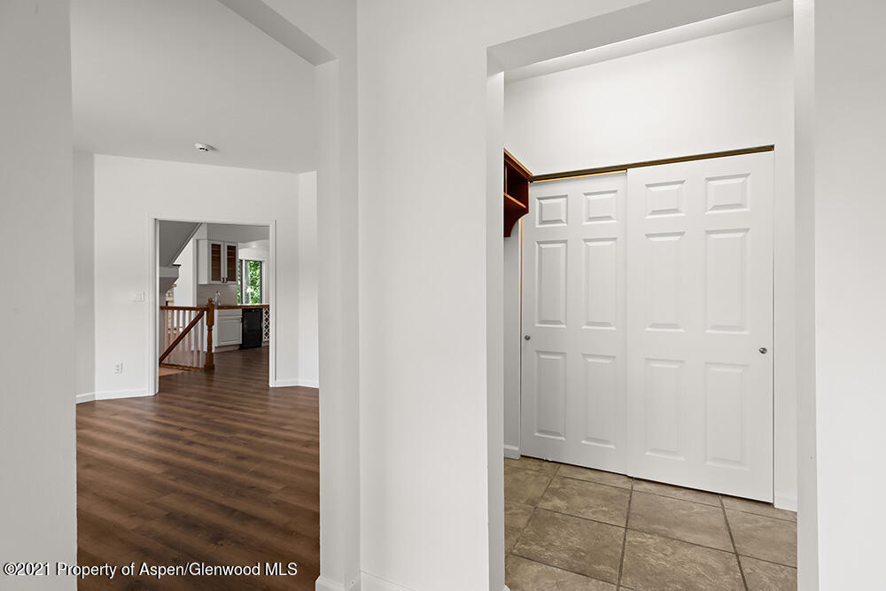 400 Medicine Bow Road Aspen, CO 81611 - Photo 41 of 58 a view of a hallway with wooden floor and front door