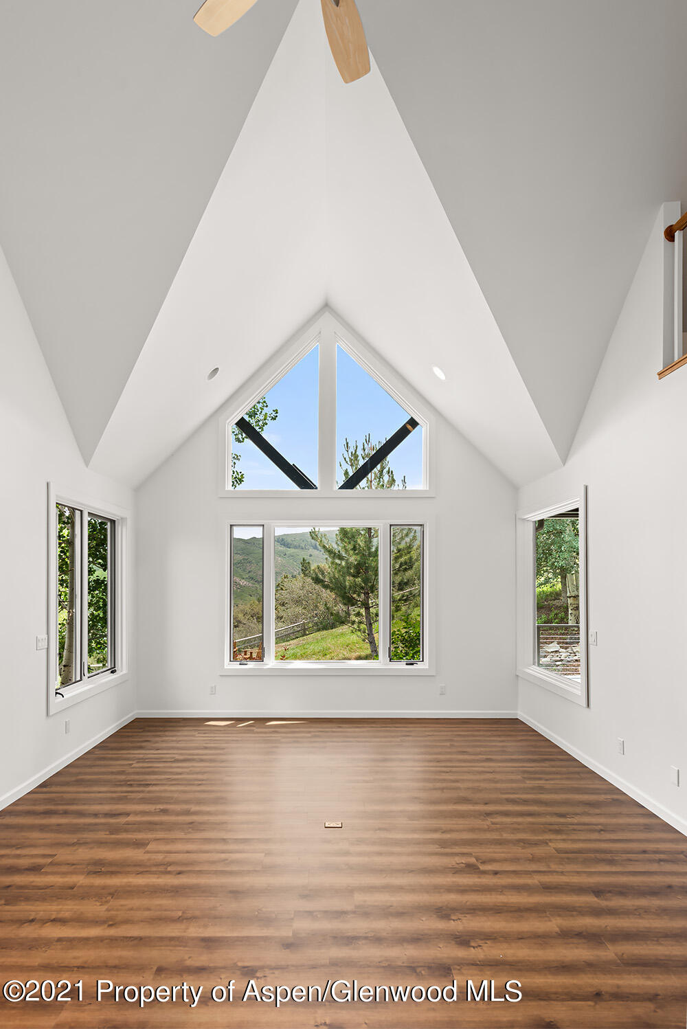 400 Medicine Bow Road Aspen, CO 81611 - Photo 8 of 58 a view of an empty room with wooden floor and a window