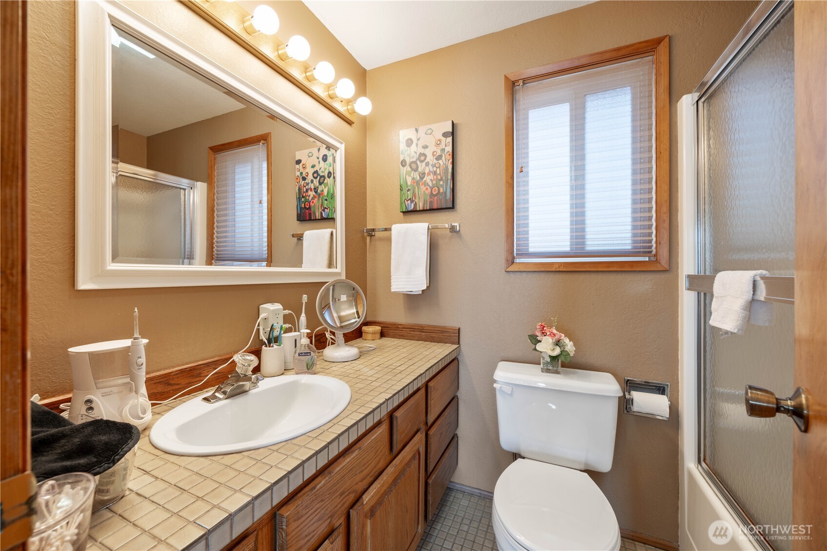 217 Riviera Drive Chelan, WA 98816 - Photo 13 of 38 a bathroom with a granite countertop toilet sink and mirror