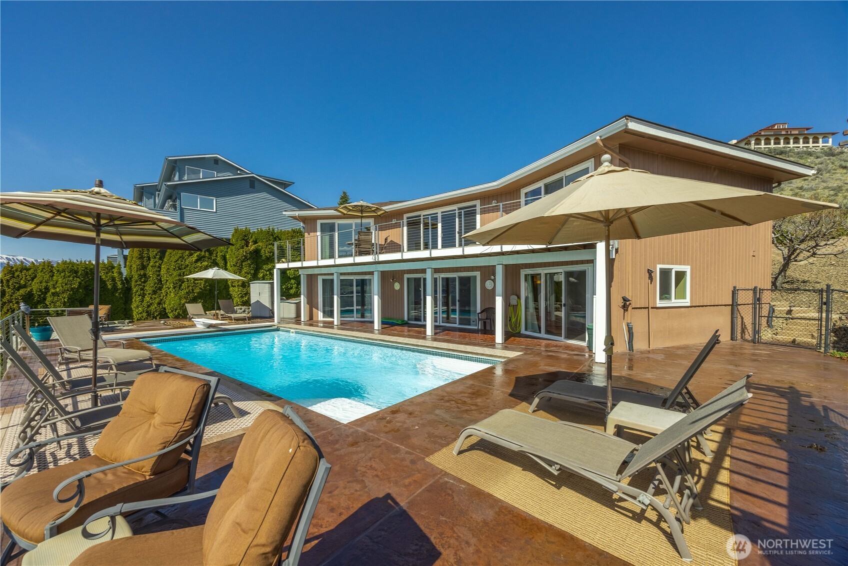 217 Riviera Drive Chelan, WA 98816 - Photo 2 of 38 a view of a house with pool and chairs
