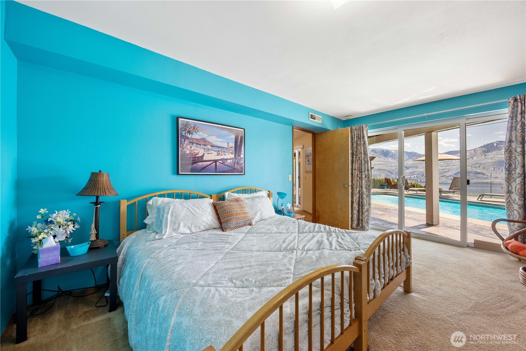 217 Riviera Drive Chelan, WA 98816 - Photo 23 of 38 a bedroom with a bed and large windows