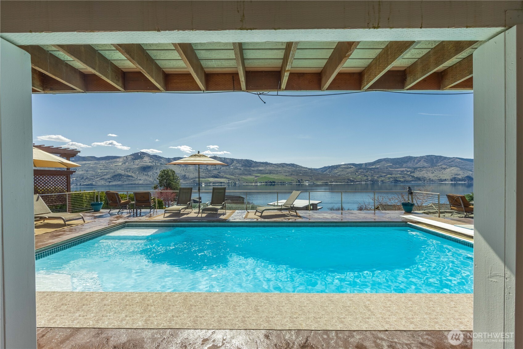 217 Riviera Drive Chelan, WA 98816 - Photo 6 of 38 a view of a swimming pool and lounge chair