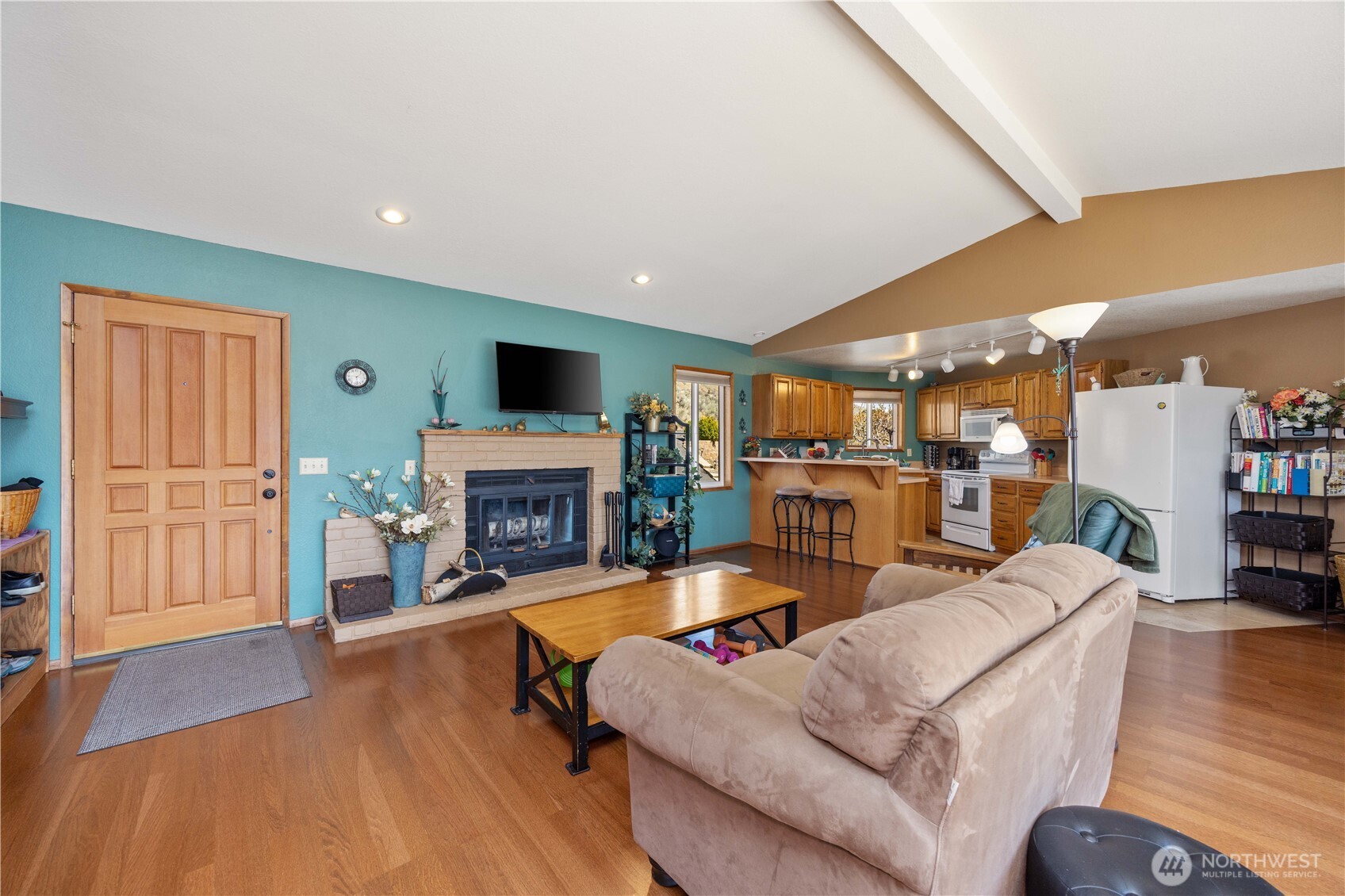 217 Riviera Drive Chelan, WA 98816 - Photo 8 of 38 a living room with furniture a fireplace and a flat screen tv