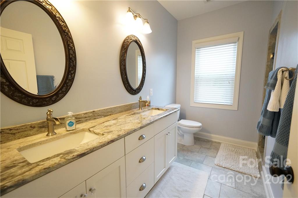 970 Lola Road Chester, SC 29706 - Photo 11 of 39 a bathroom with a granite countertop double vanity sink and a mirror