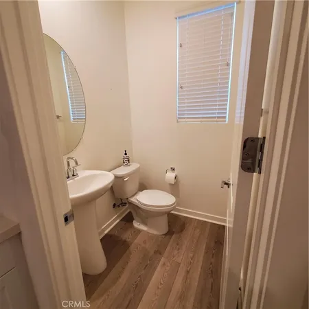 a bathroom with a toilet a sink and a mirror
