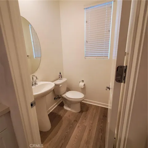 a bathroom with a toilet a sink and a mirror