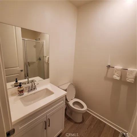 a bathroom with a sink toilet and mirror