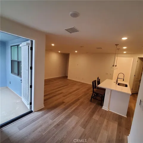 a view of a room with wooden floor