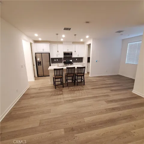 a view of kitchen with sink microwave and refrigerator
