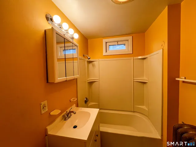 a bathroom with a bathtub and shower