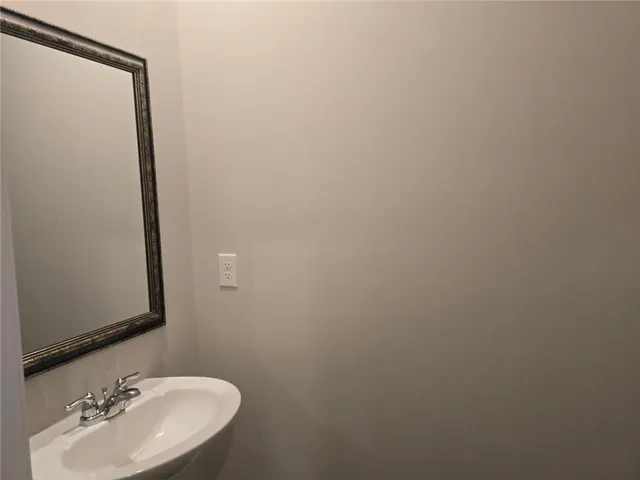 a bathroom with a sink and mirror