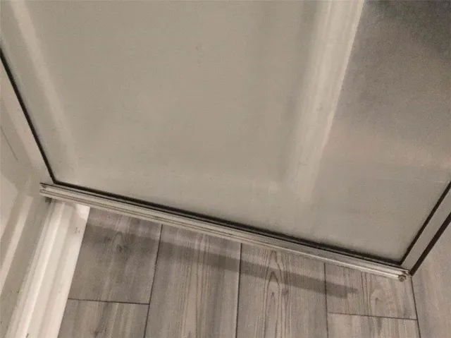 a view of a car garage with wooden floor