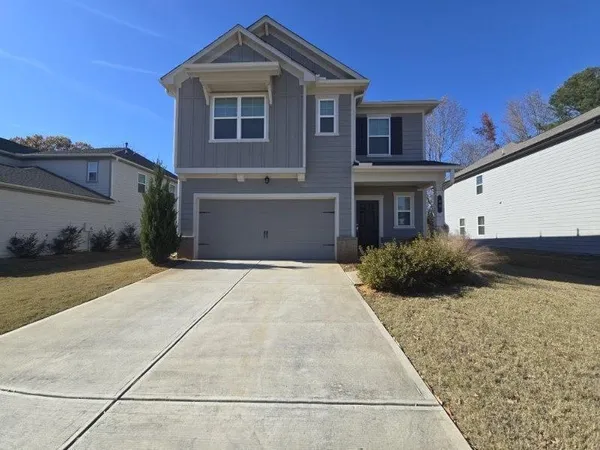 a front view of a house with a yard and garage