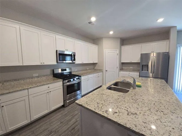 a kitchen with a sink stove and refrigerator