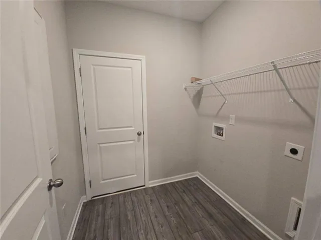 a view of a room with wooden floor and cabinet