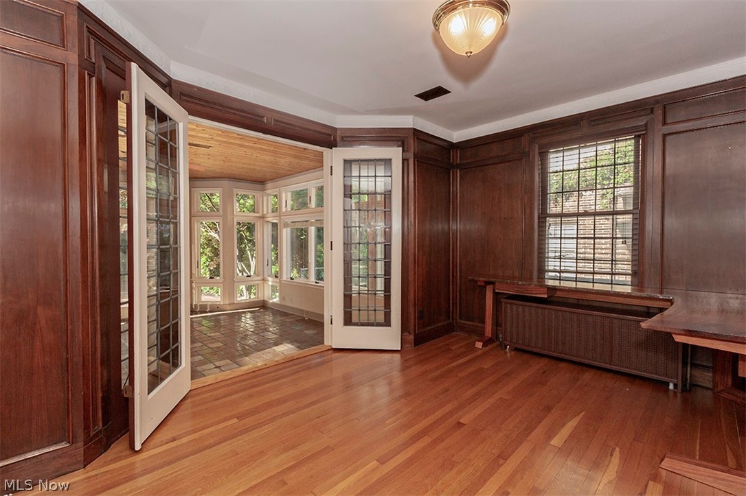 2830 East Overlook Road Cleveland, OH 44118 - Photo 11 of 32 Paneled Library, Study Office or Den with hardwood flooring. Beautiful double French doors with leaded glass open to a Solarium which the current owners use as a Family Room.