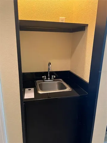 a bathroom with a sink and mirror