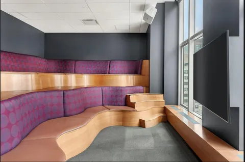 a bathroom with a bathtub and a potted plant