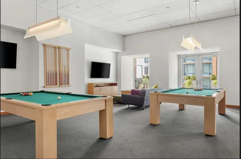 a room with furniture a flat screen tv and a table