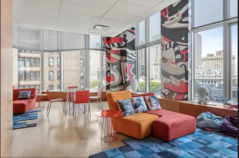 a living room filled with furniture and a floor to ceiling window