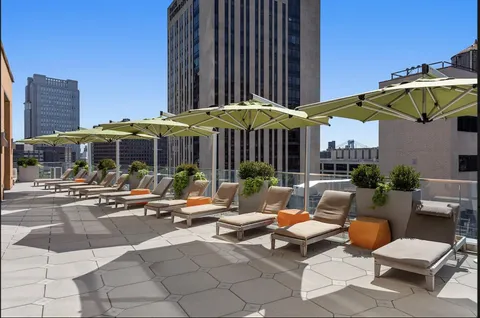 a view of a patio with a table and chairs under an umbrella