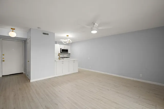 a view of kitchen with wooden floor and electronic appliances