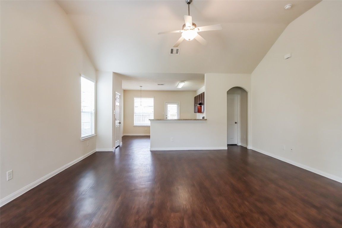 12414 Roy Mix Bohn Lane Houston, TX 77044 - Photo 6 of 13 a view of an empty room with wooden floor and a window