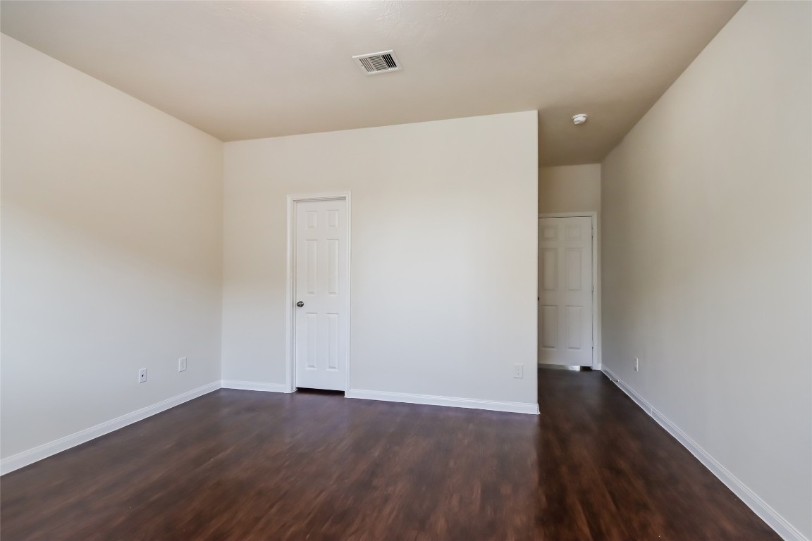 12414 Roy Mix Bohn Lane Houston, TX 77044 - Photo 9 of 13 a view of an empty room with wooden floor