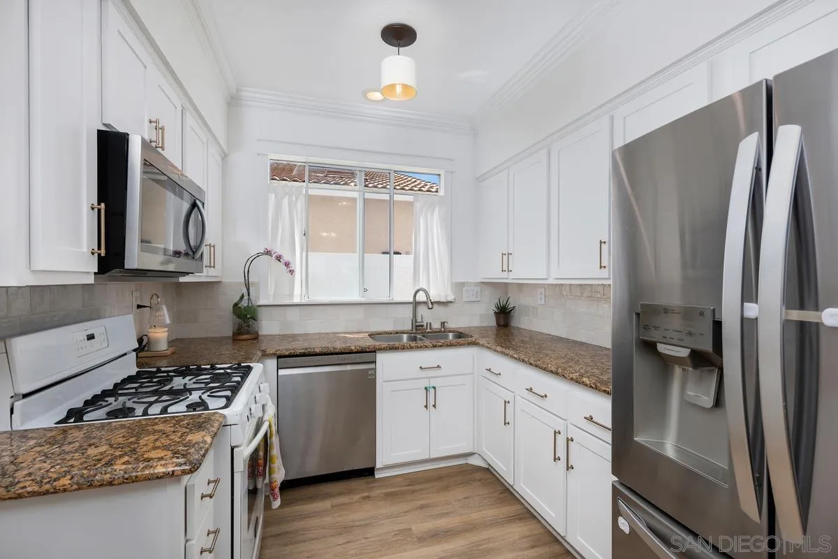 39537 Tischa Drive Temecula, CA 92591 - Photo 11 of 35 a kitchen with a sink stove and refrigerator