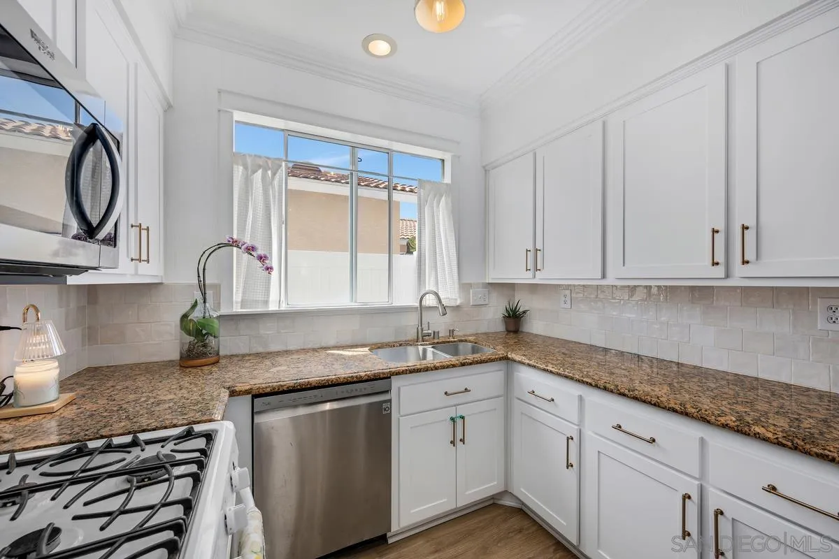 39537 Tischa Drive Temecula, CA 92591 - Photo 12 of 35 a kitchen with granite countertop a sink a stove and cabinets