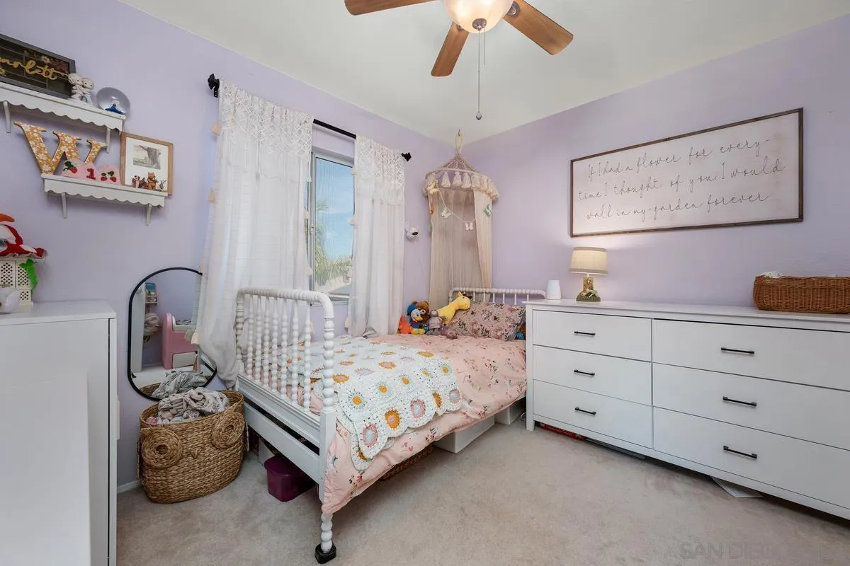 39537 Tischa Drive Temecula, CA 92591 - Photo 17 of 35 a bedroom with a bed and a chandelier