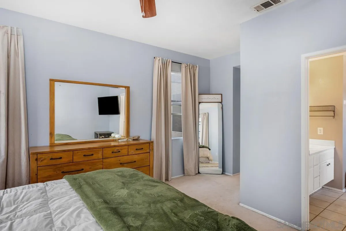 39537 Tischa Drive Temecula, CA 92591 - Photo 21 of 35 a bedroom with a bed and a flat tv screen on dresser