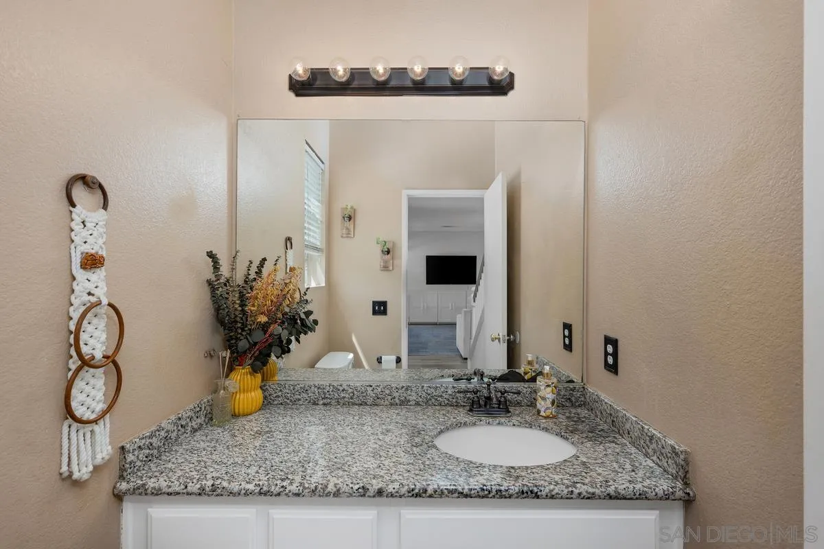 39537 Tischa Drive Temecula, CA 92591 - Photo 8 of 35 a bathroom with sink granite and a mirror