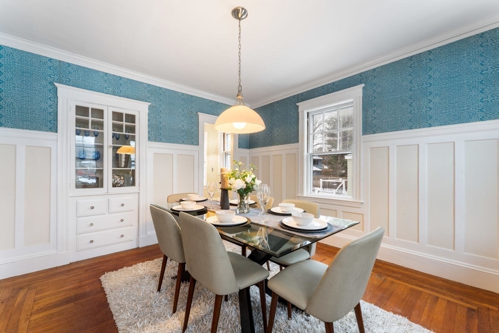 10 Hinckley Road Newton, MA 02468 - Photo 14 of 41 a dining room with furniture a chandelier and wooden floor