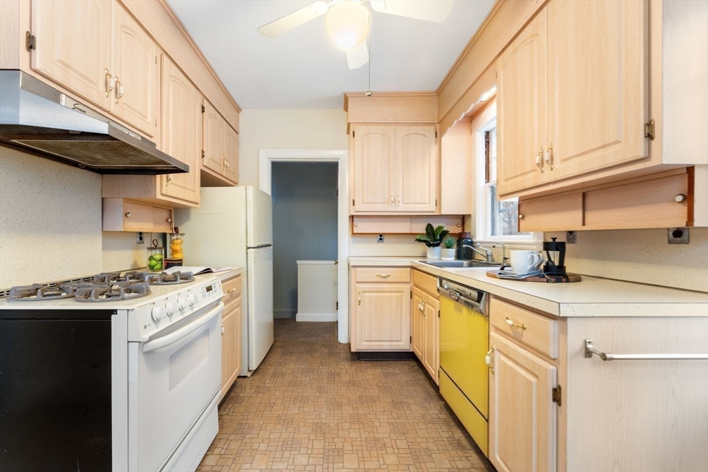 10 Hinckley Road Newton, MA 02468 - Photo 15 of 41 a kitchen with a sink a stove and cabinets