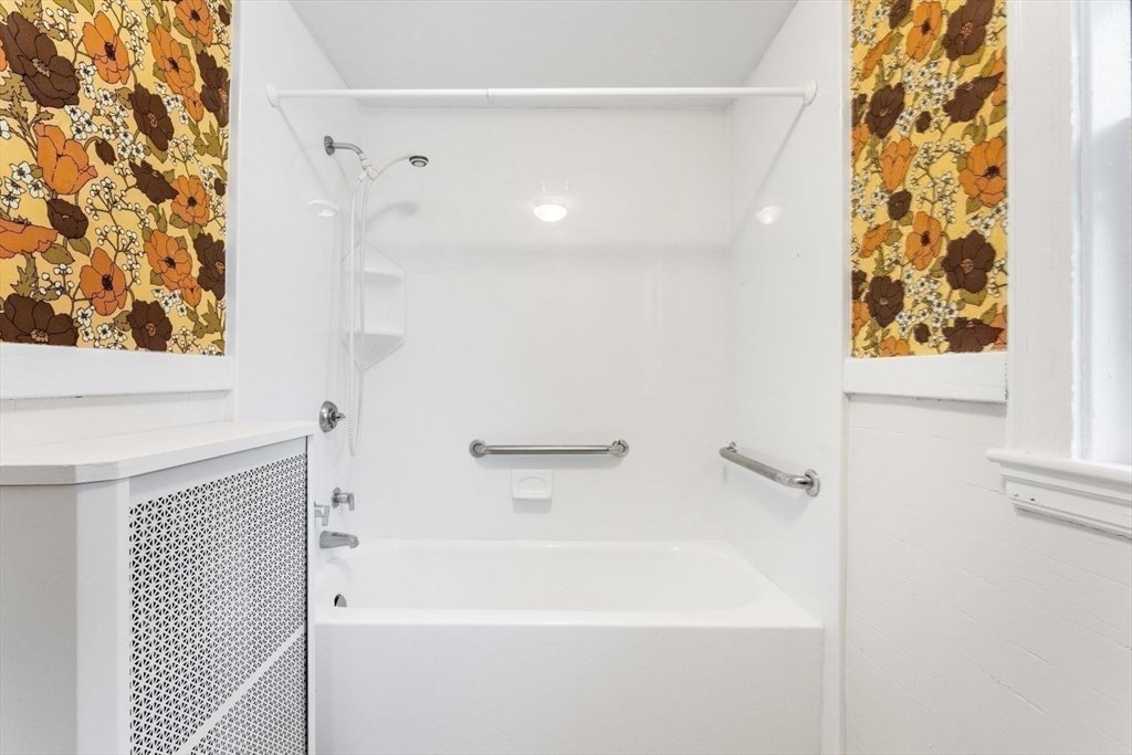 10 Hinckley Road Newton, MA 02468 - Photo 19 of 41 a bathroom with a bathtub and shower