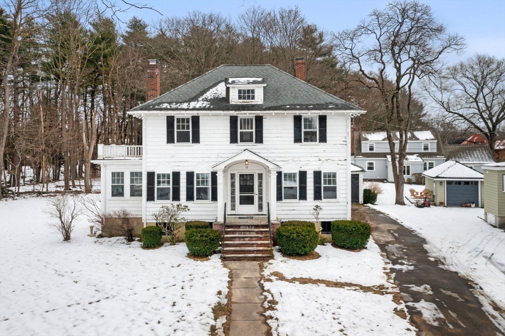 10 Hinckley Road Newton, MA 02468 - Photo 2 of 41 a front view of a house with a yard covered with snow and trees