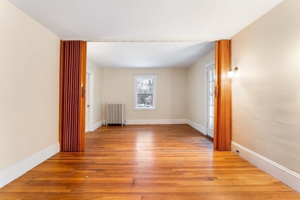 10 Hinckley Road Newton, MA 02468 - Photo 31 of 41 an empty room with wooden floor and windows