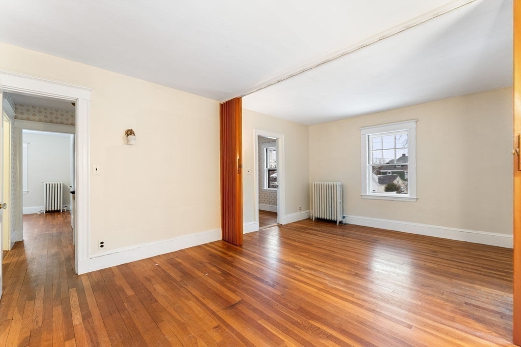 10 Hinckley Road Newton, MA 02468 - Photo 32 of 41 an empty room with wooden floor and windows