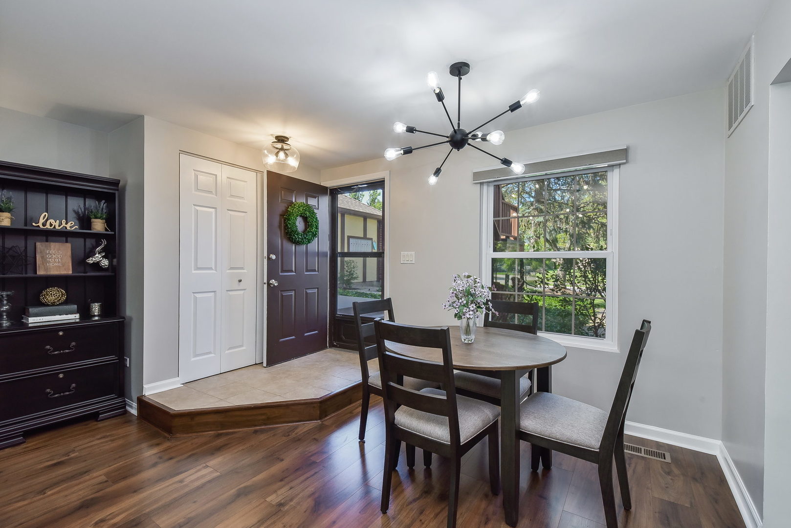 367 Sandhurst Circle, Unit 5 Glen Ellyn, IL 60137 - Photo 2 of 10 a view of a dining room with furniture window and wooden floor